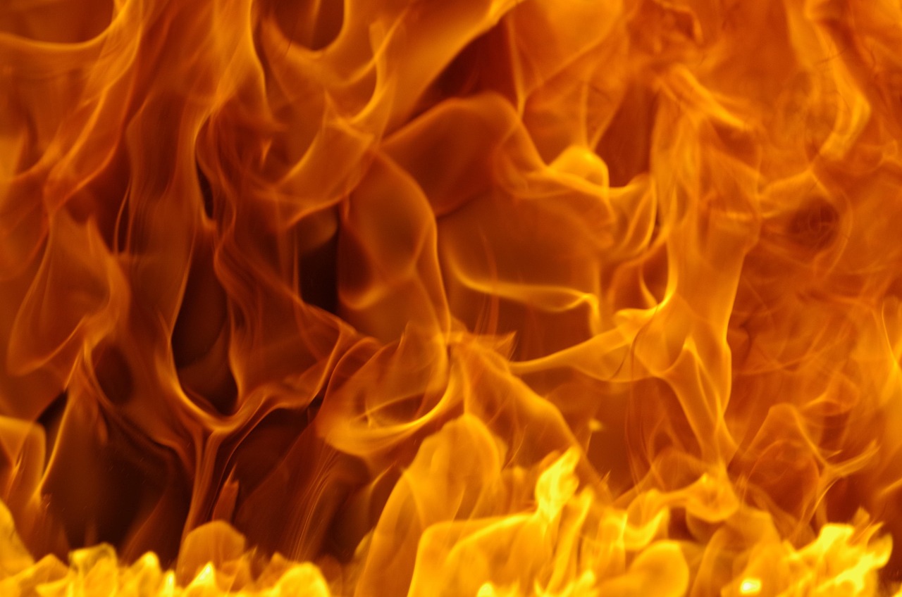 Bright orange and yellow flames creating a swirling fire pattern.