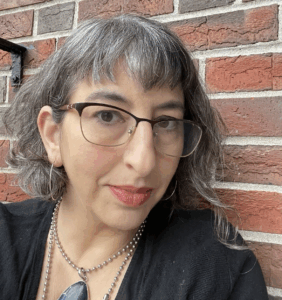 Rabbi Danya Ruttenberg has gray-brown hair and wears glasses