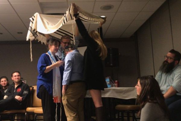 a blessing of two people under a tallit