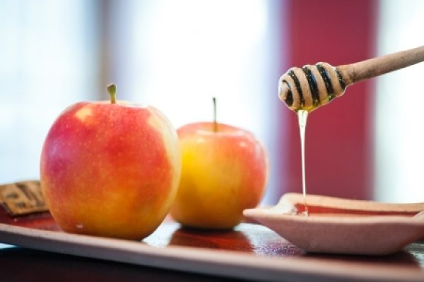 two apples and a dish of honey