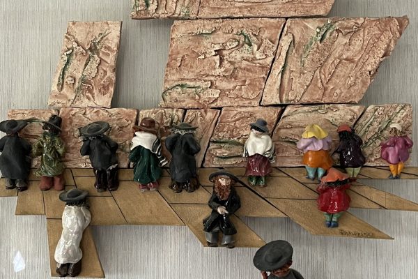 a sculpture of people praying at the Kotel