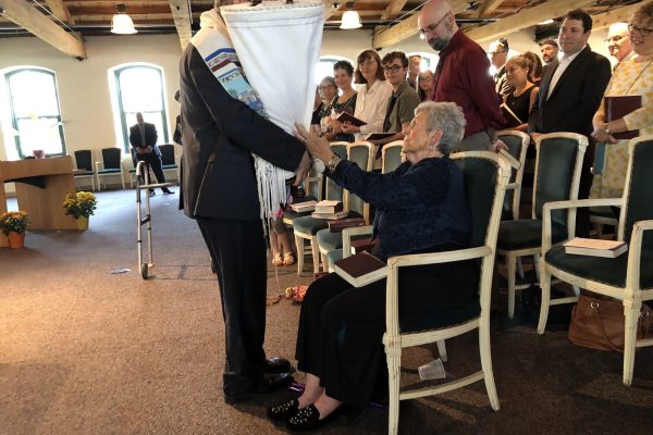 A rabbi bring the Torah to a member of the congregation