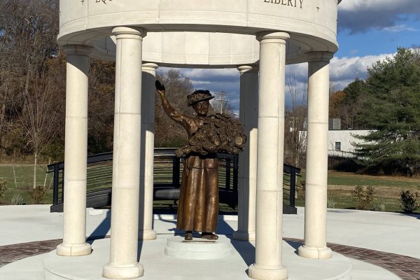 Bronze statue of a woman under a pavilion with the words Equality and Liberty inscribed above.
