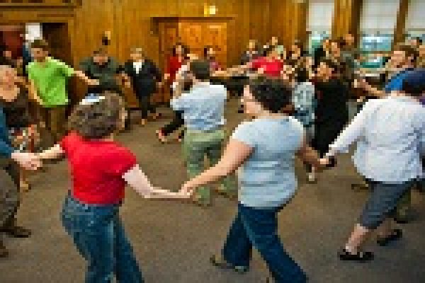 a group of people dancing with the Torah