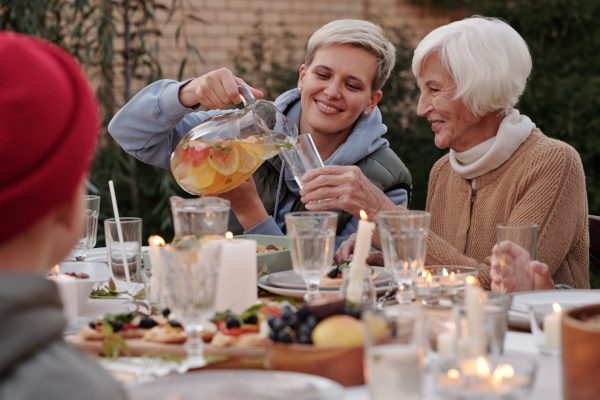 adult grandchild and grandmother at dinner table