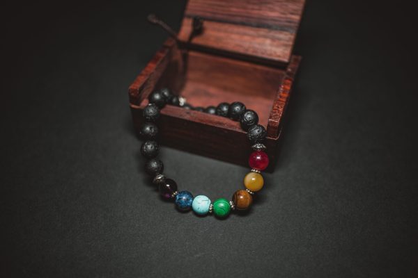 beaded bracelet draped over wooden box