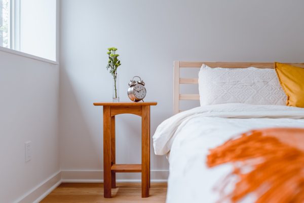 bed and nightstand in bright room