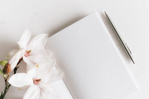 blank notebook with flowers and pen