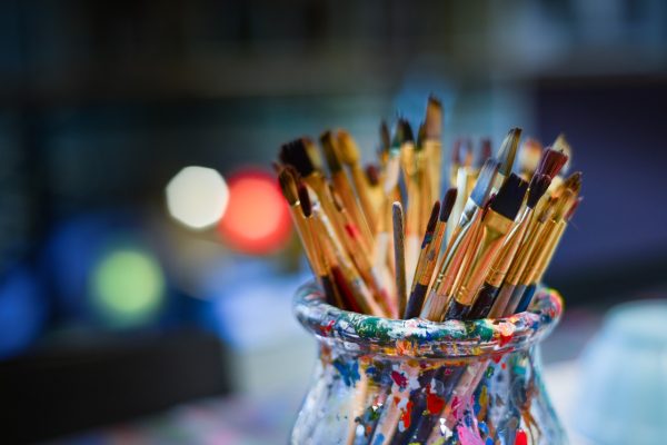 a jar of paint brushes