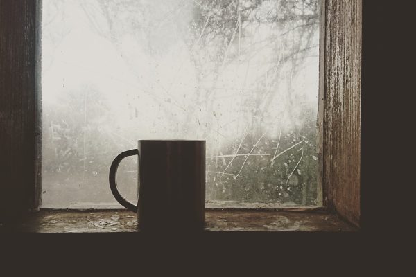 a coffee mug sitting on a sunny window