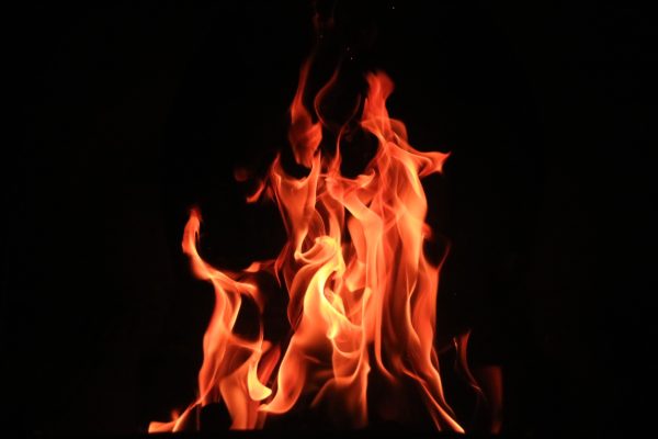 fire burning against a black sky