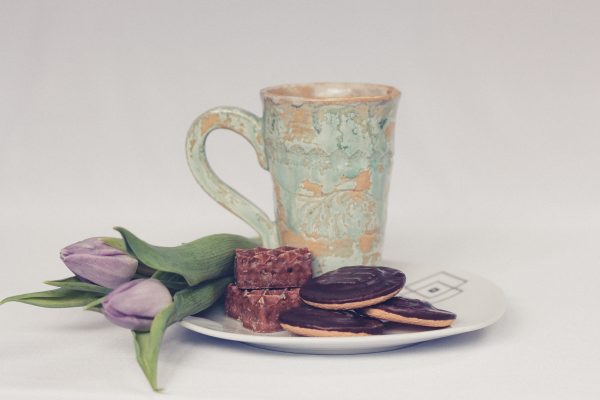 cup of tea with cookies and tulips
