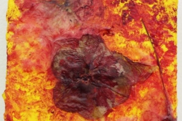 Abstract painting with rich red and yellow tones, featuring dried leaves embedded in textured layers.