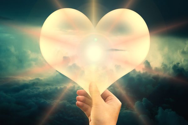 A white heart beaming with light