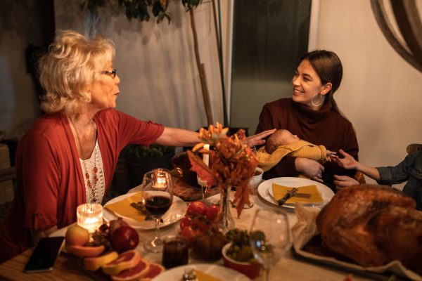family with newborn around dinner table