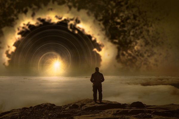 a person stands looking into the light