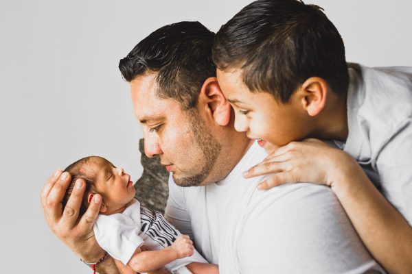 father son and newborn baby