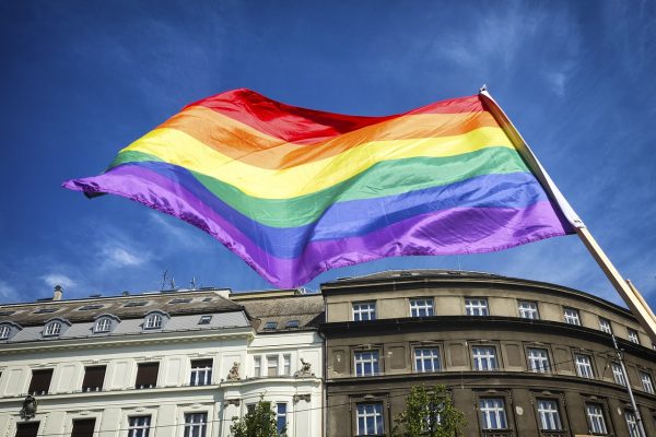 a pride flag over an old building