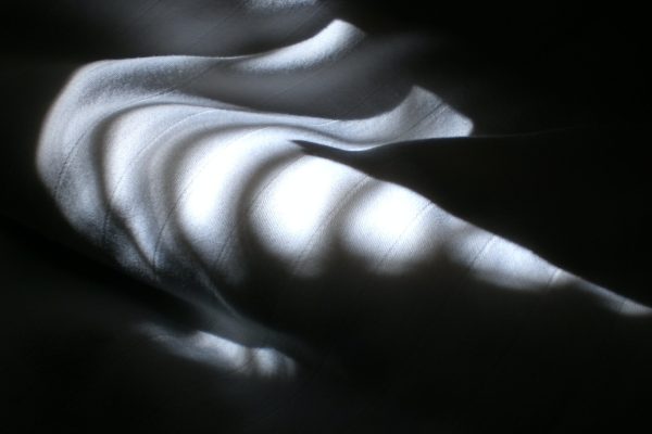 folded white fabric in shadows