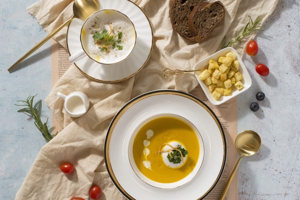 two bowls of soup, bread and soup nuts