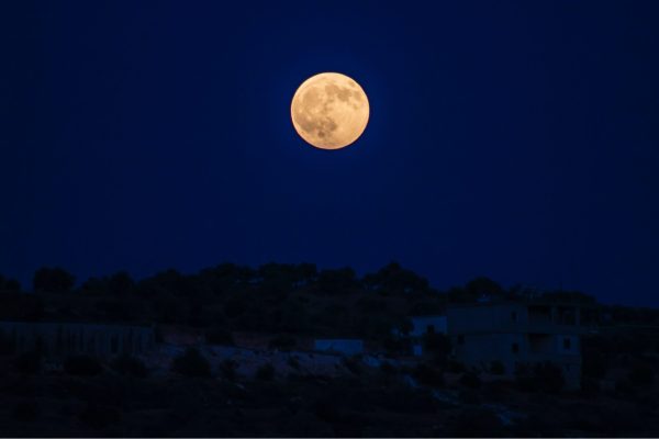 full moon over dark landscape