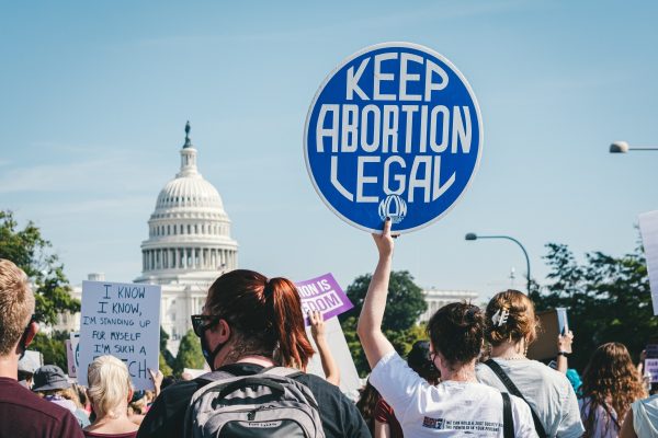 Protesters holding signs, including a prominent one saying Keep Abortion Legal, near the U.S. Capitol building.