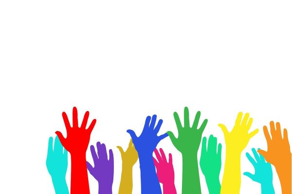 hands of different rainbow colors reach up against a white background