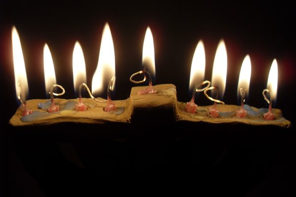 a hanukkiah with lit candles