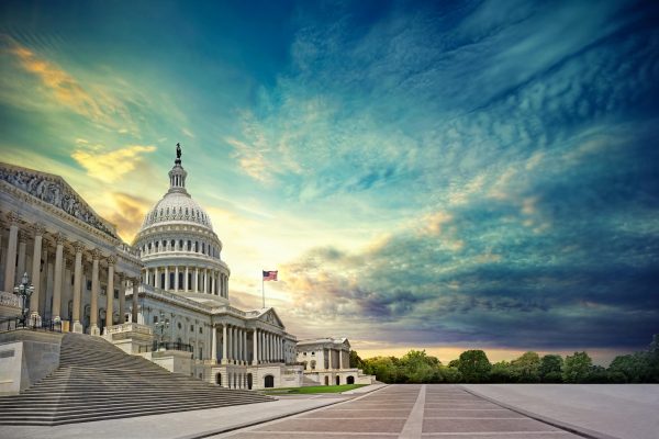 U.S. Capitol building at sunset with a dramatic sky and empty steps in the foreground.