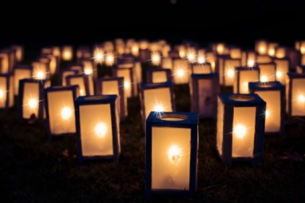 Glowing lanterns arranged outdoors at night, creating a warm and peaceful ambiance.