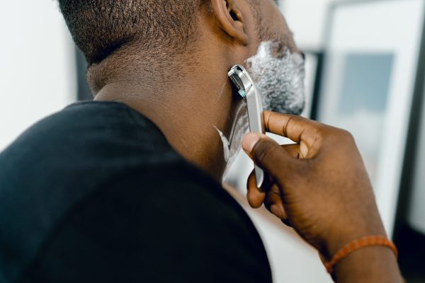 man shaving his beard