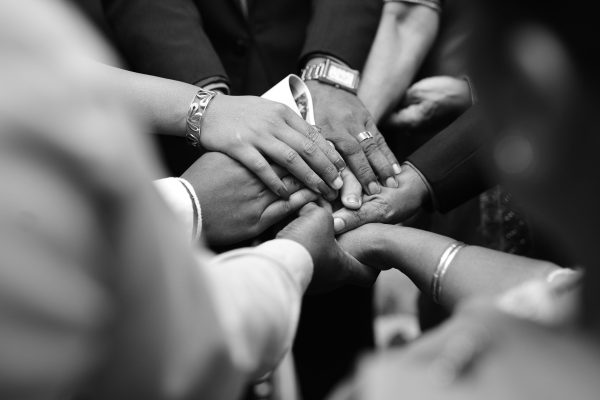 many hands touching