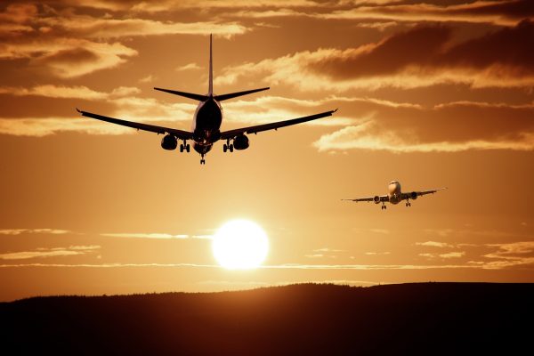 airplanes flying over the sunset