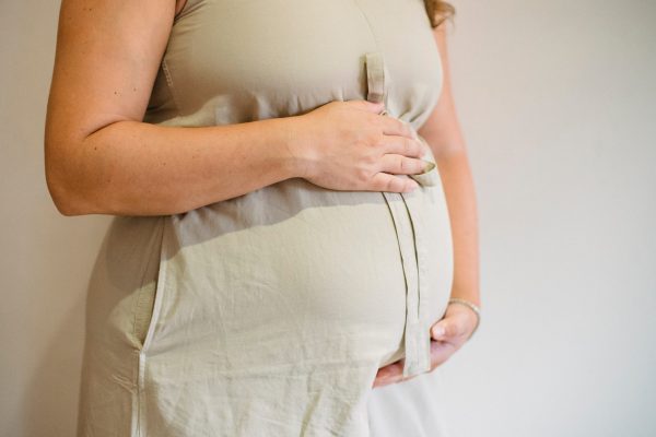 pregnant woman holding belly