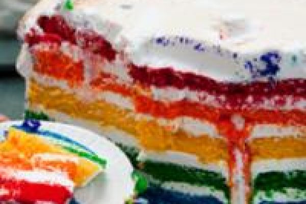 A sliced rainbow layer cake with colorful frosting layers and white icing on top.