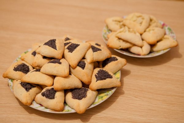 two plates filled with hamantashen