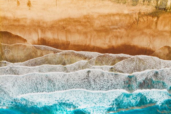 waves rippling and crashing to shore