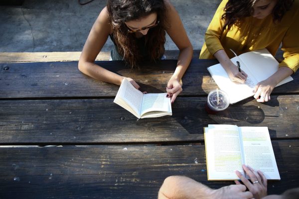 two college women studying at a picnic table