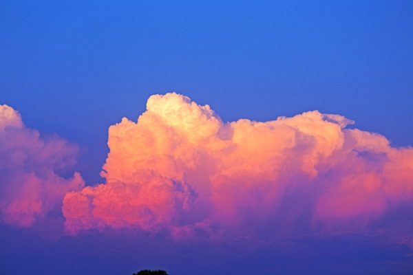 deep blue sky with cloud in white, light pink, darker pink, and purple