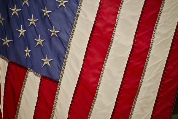 Close-up of a U.S. flag featuring stars on a blue field and red and white stripes.
